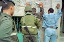 IDF in action: 'Nice Motherfucker' and a friend detaining two Palestinian students because they refused to read the writing on his back.