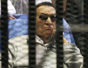 File photo of Egypt's ousted President Mubarak sitting inside a dock at the police academy